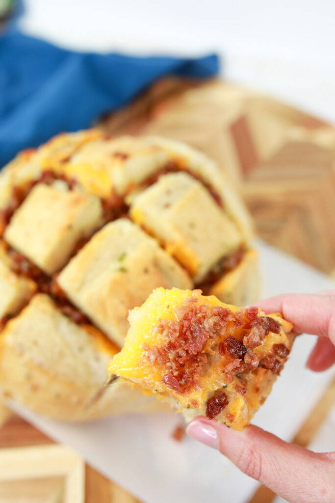baked pull apart bread in someones hand