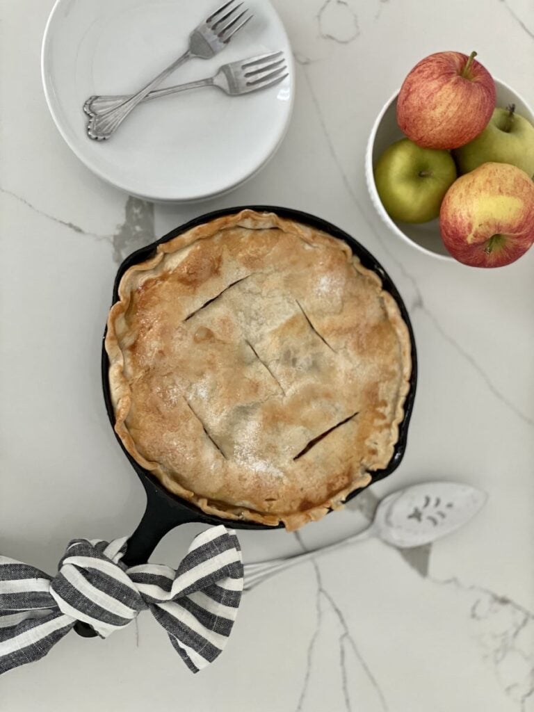 Cast Iron Skillet Apple Pie Finished with Plates and Apples
