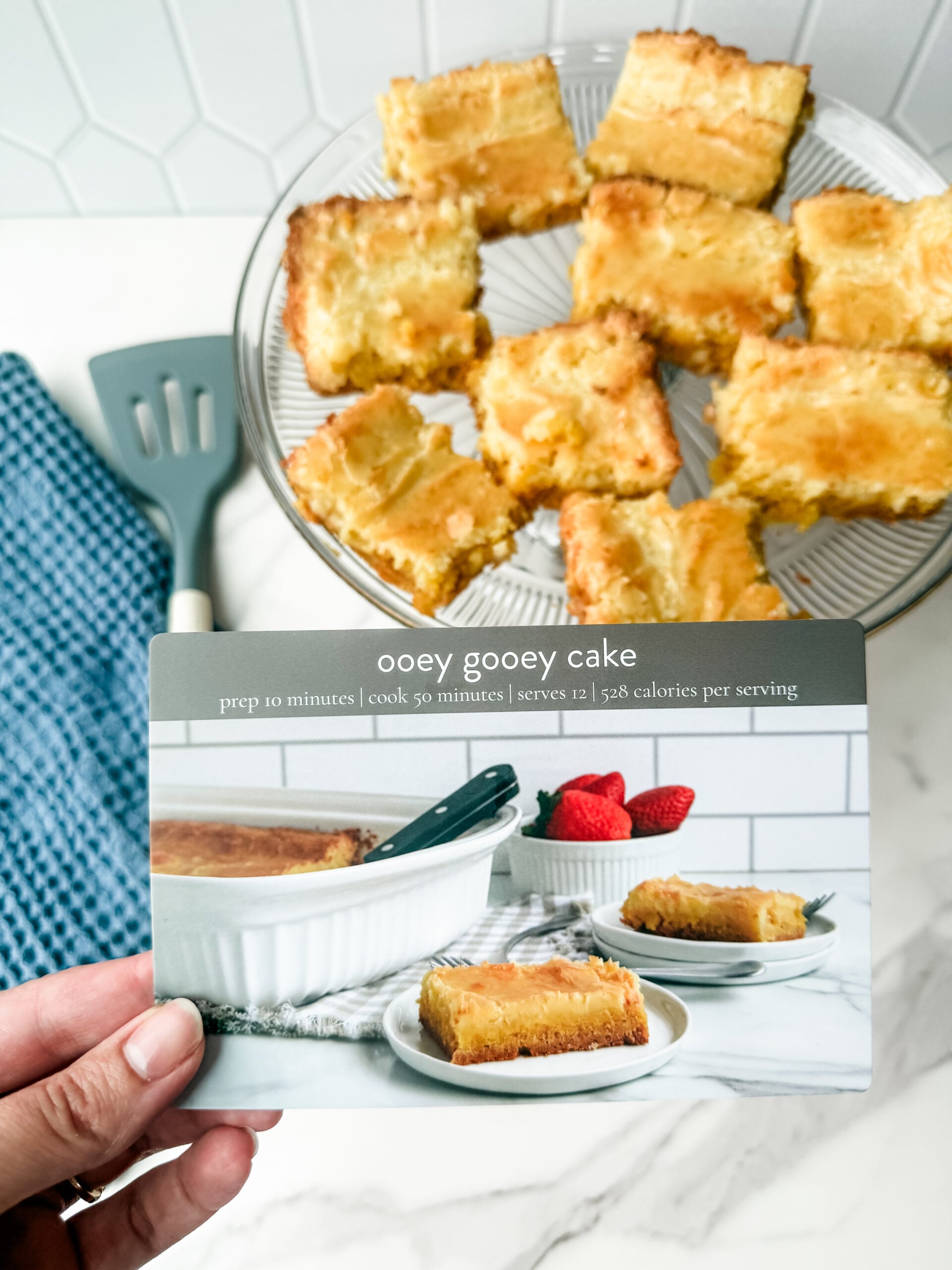 ooey gooey cake on platter with recipe card
