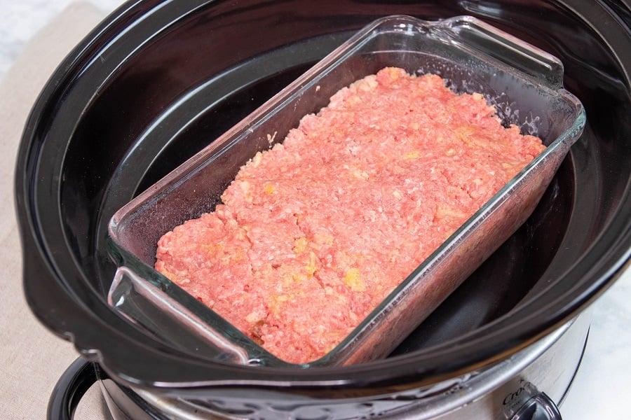meatloaf pan sitting in crockpot ready to cook