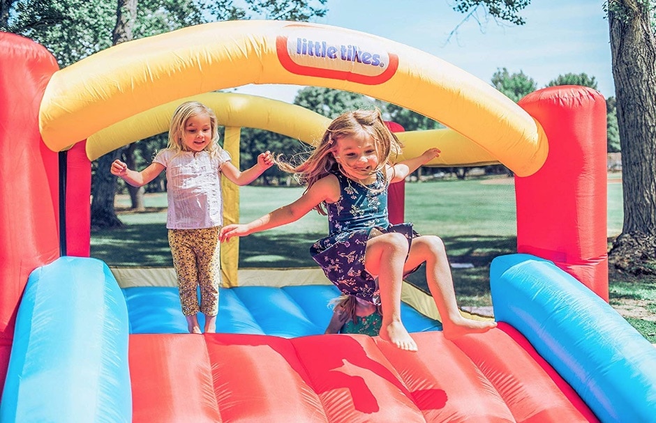 kids playing on little tikes jump 'n slide bouncer