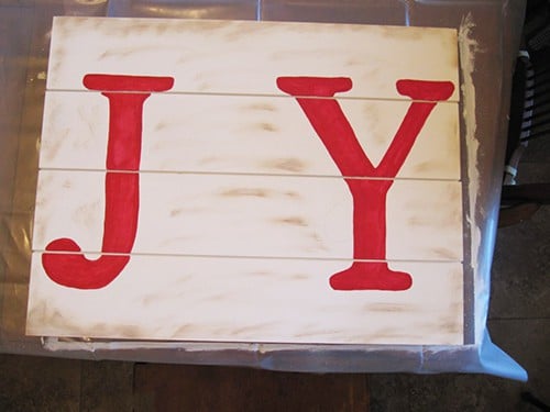 Adding stencils to DIY Farmhouse Christmas Signs