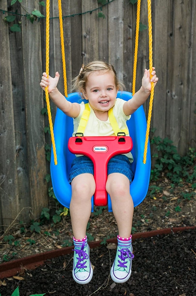 little tikes swing with toddler in swinging
