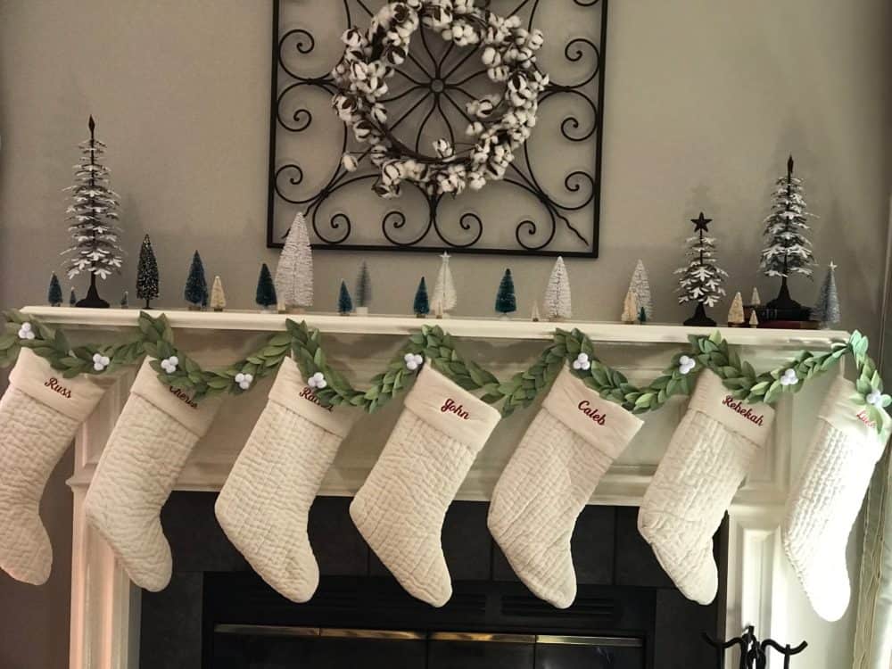 Christmas Paper Garland on mantle with stockings 