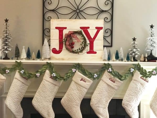 Christmas Paper Garland on mantle with stockings and joy sign 