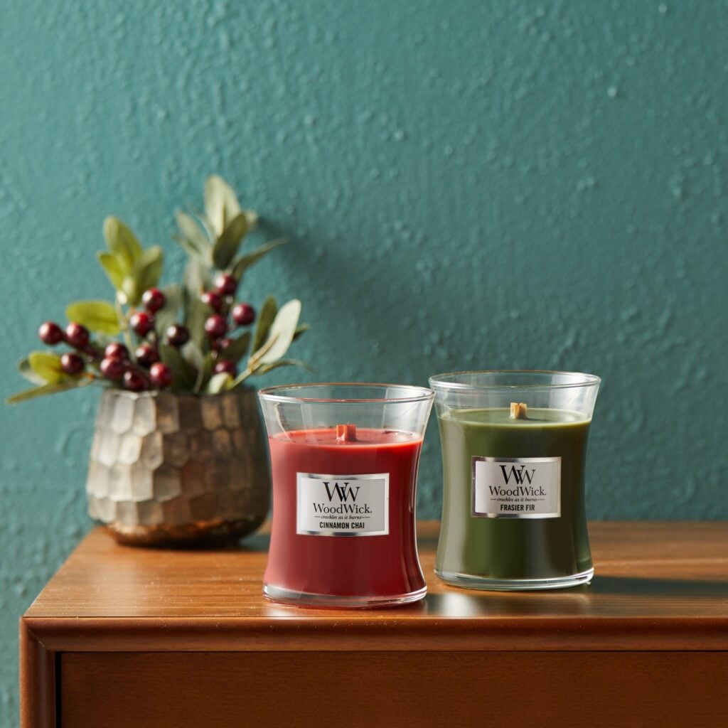 2 WoodWick candles on table