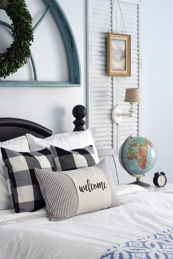 finished diy throw pillow cover on bed with other pillows