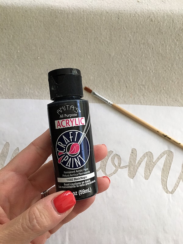 acrylic black paint in hand 