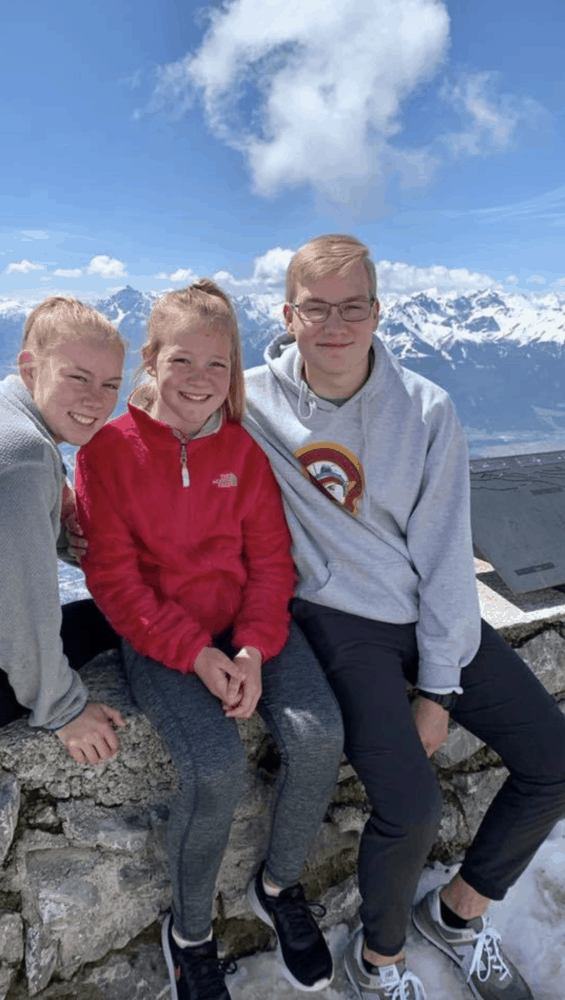 children in front of a snowy mountain
