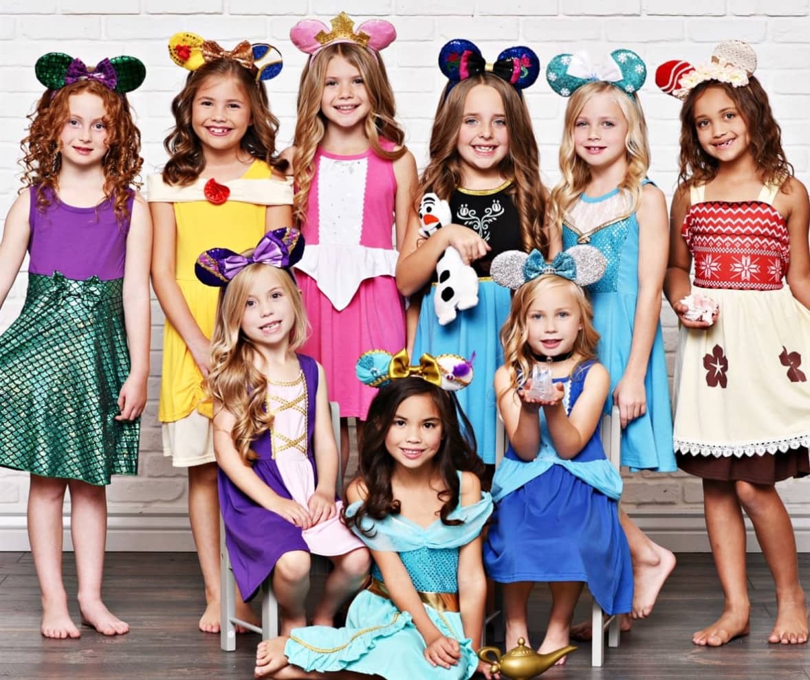 girls wearing disney inspired dresses with ears 