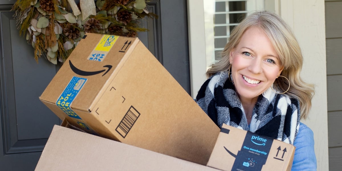 woman holding amazon boxes