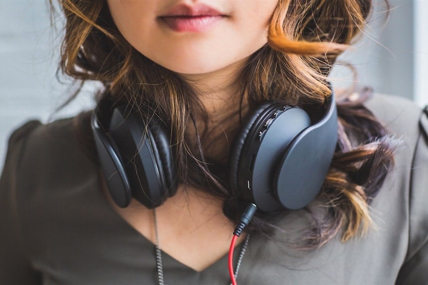 woman wearing headphones around neck