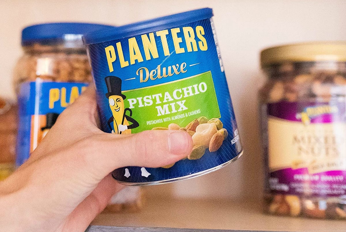 hand holding planters nuts