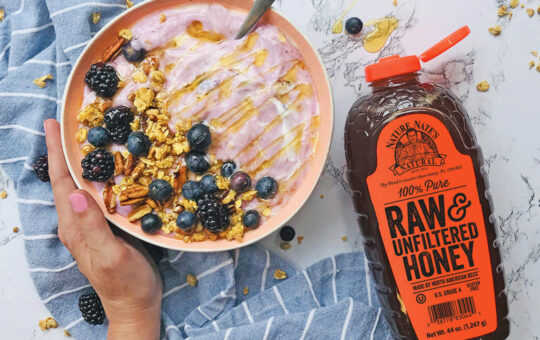 bottle of honey on acai bowl