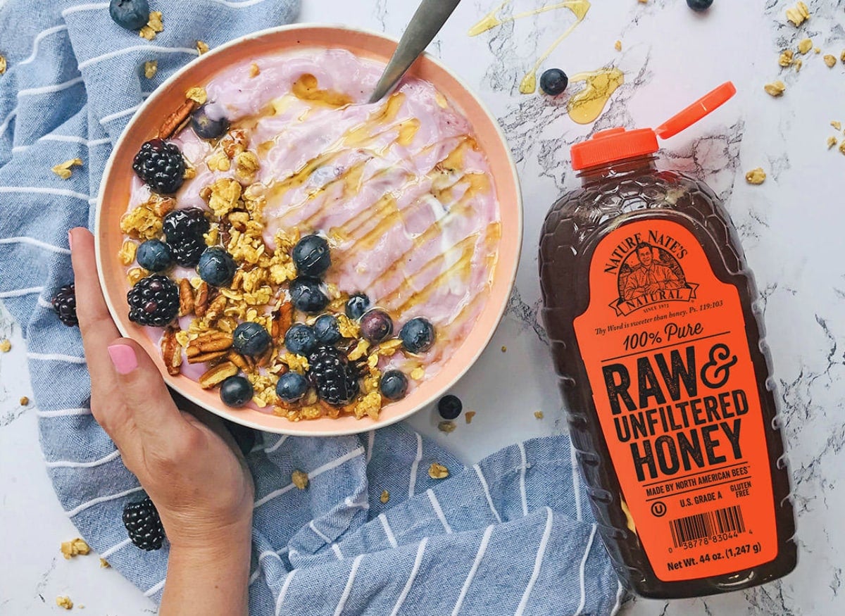 bottle of honey on acai bowl