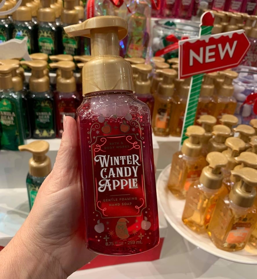 hand holding up Winter Candle Apple hand soap