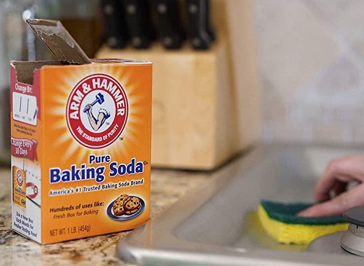baking soda with scrub sponge on sink