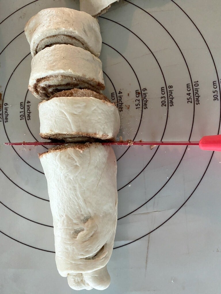 cutting cinnamon rolls