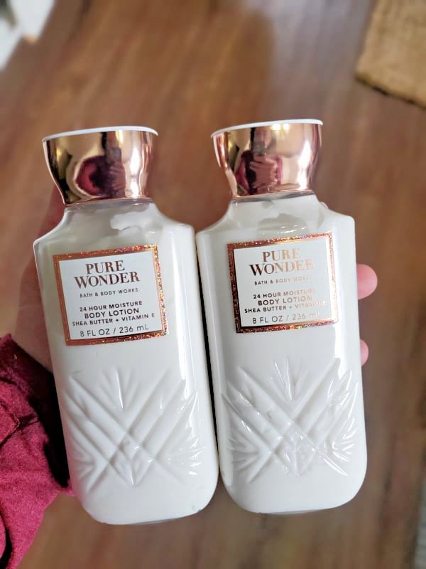 hand holding pure wonder body lotion