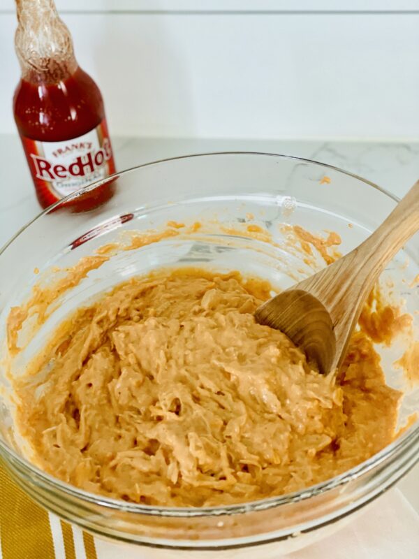 mixing buffalo chicken dip with franks hot sauce 