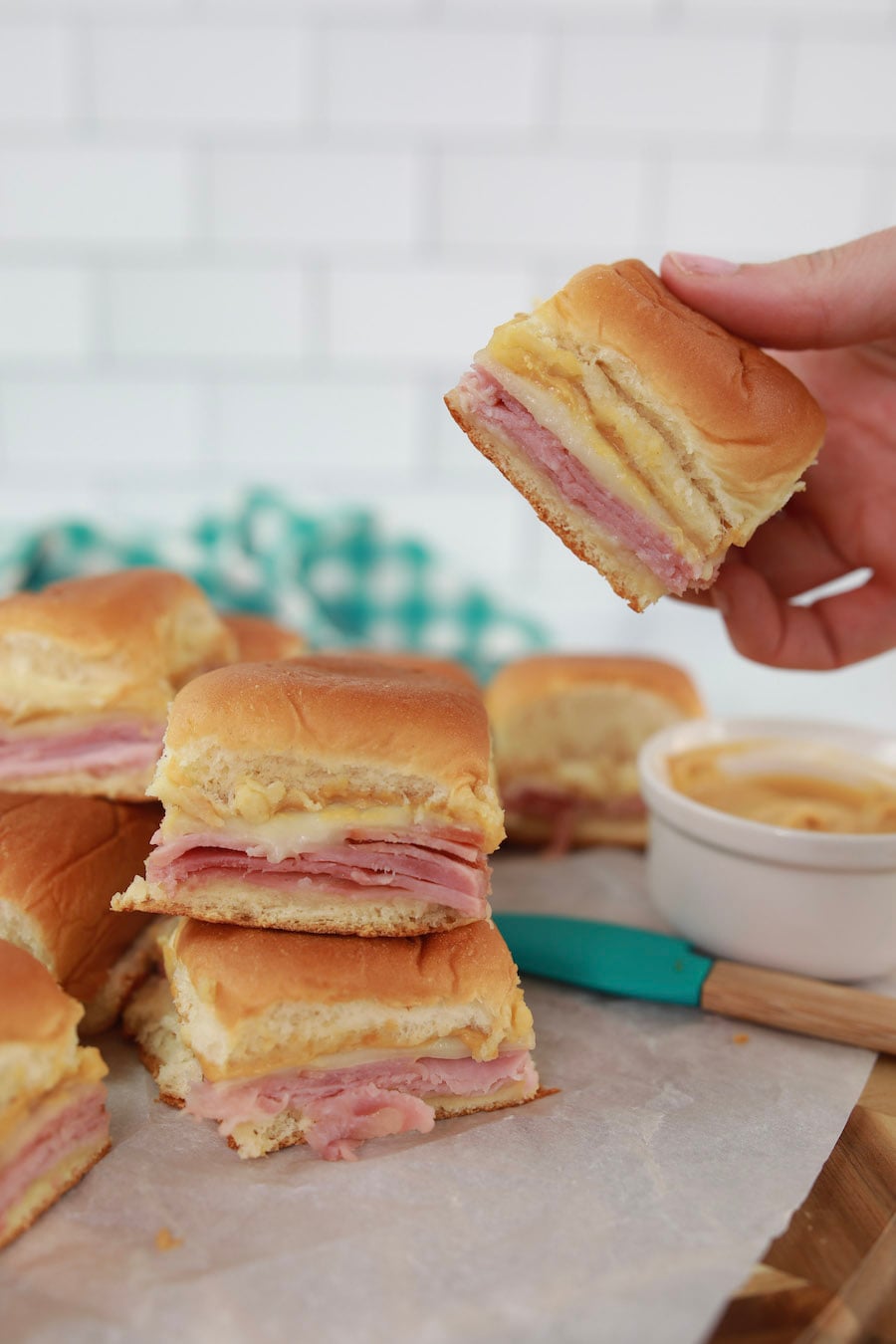 Ham and Cheese Slilders In hand and stacked