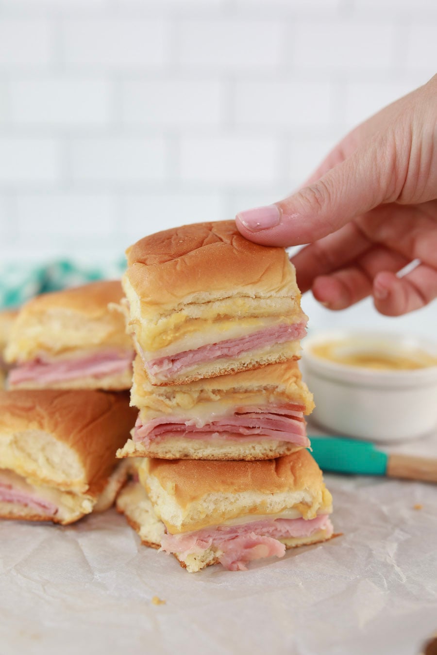 Ham and Cheese Slilders Someone Picking up Sandwich