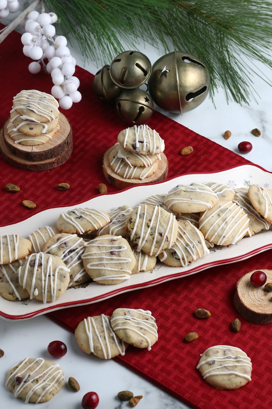 cranberry cookie on platter with icing and Christmas decorations