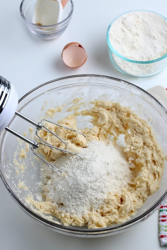 Adding flour to cookie mixture