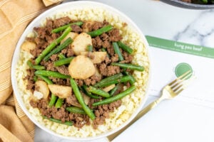 kung pao beef Finished on Plate with fork and Recipe Card