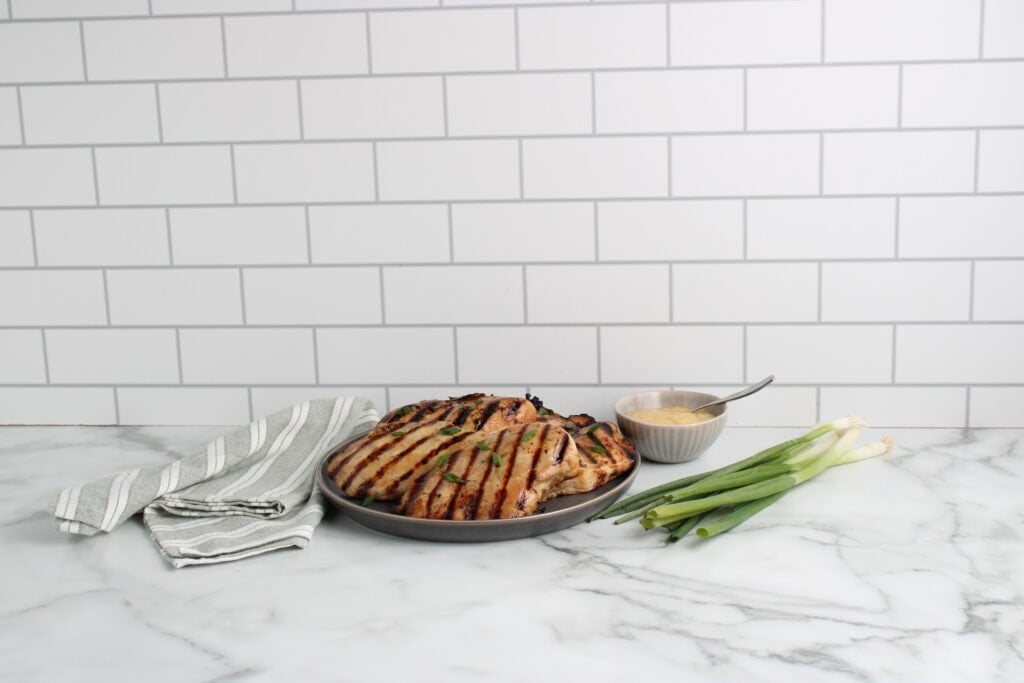 Honey Garlic Grilled Chicken on plate with green onions