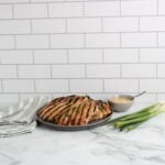 Honey Garlic Grilled Chicken on plate with green onions