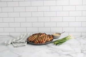 Honey Garlic Grilled Chicken on plate with green onions