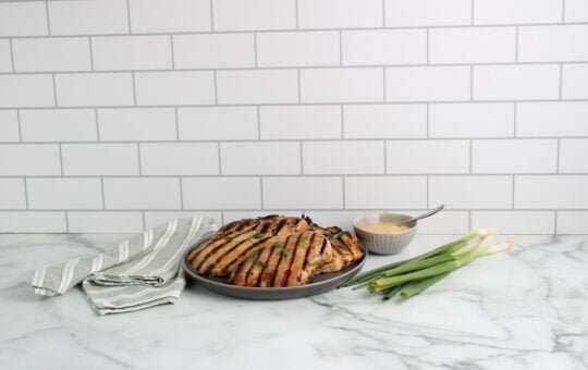 Honey Garlic Grilled Chicken on plate with green onions