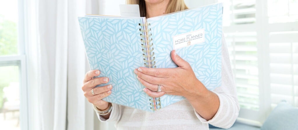 woman holding 2022 home planner blue