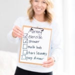 Laurie holding sign with morning checklist of things to do