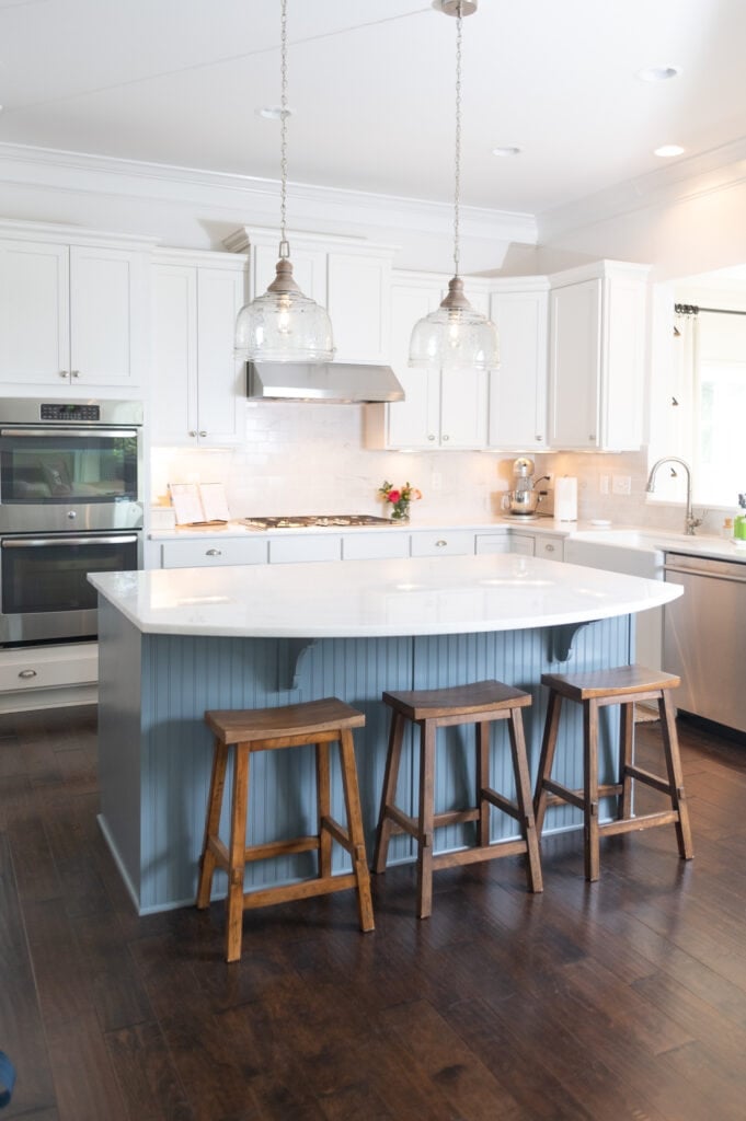 White kitchen with three wooden bar stools