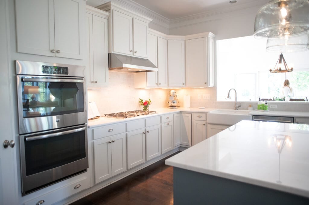 White kitchen with colorful flowers on counter