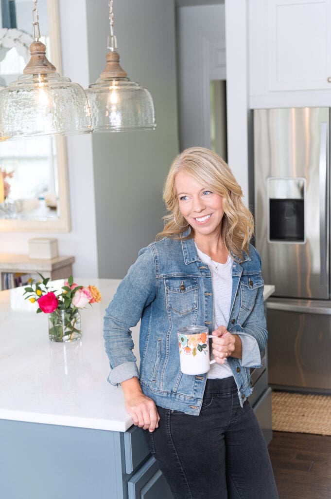 Laurie leaning on kitchen counter with rifle coffee mug