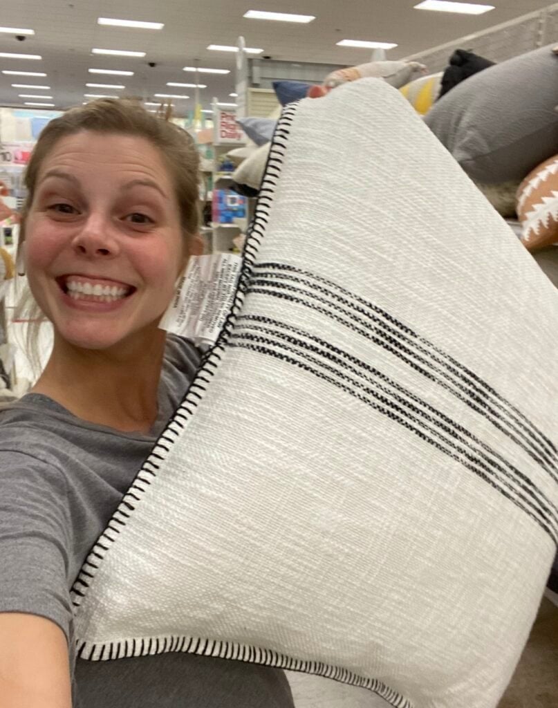 woman holding throw pillows from target 