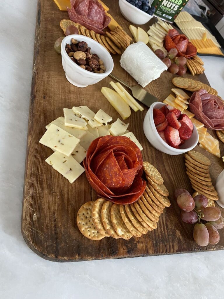 charcuterie board with crackers, meats and cheeses