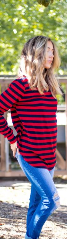 Narrow view black and red striped top on woman wearing jeans with long blonde hair