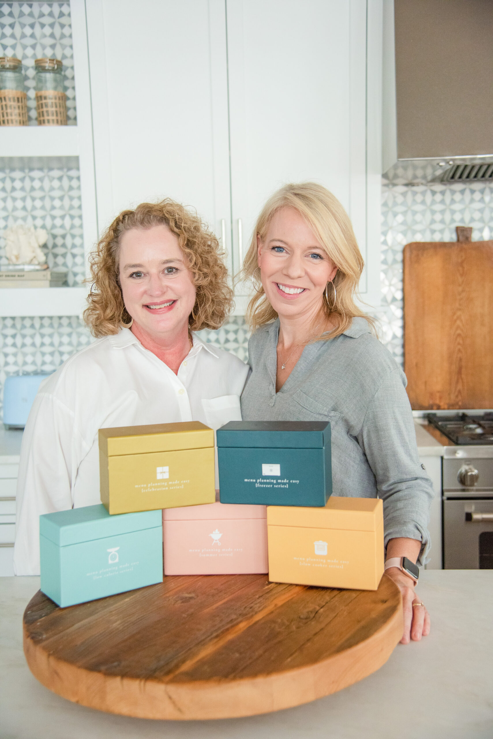 recipe boxes on platter with cheree and laurie behind