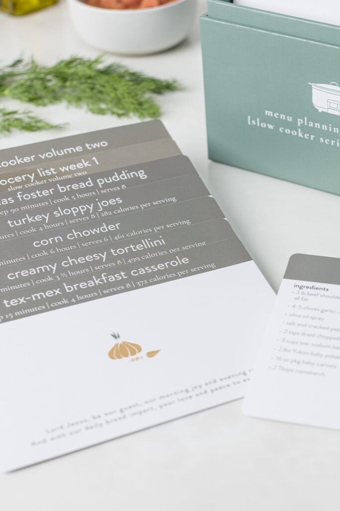 Slow cooker volume 2 box with grocery list and recipes on kitchen counter