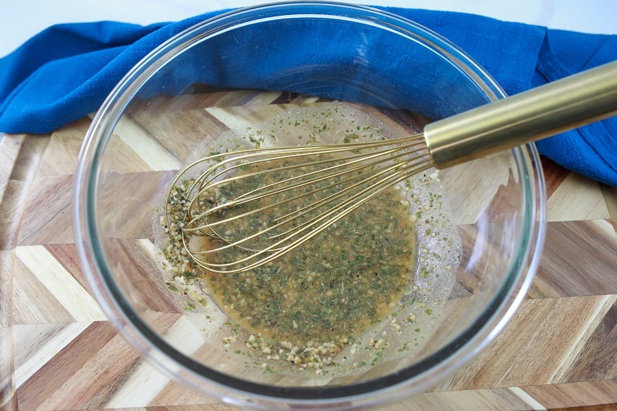 cuban pork sandwich mixing spices in bowl