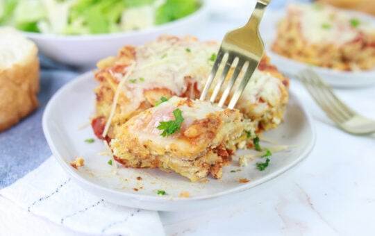 Pesto Lasagna on Plate with Fork in Lasagna