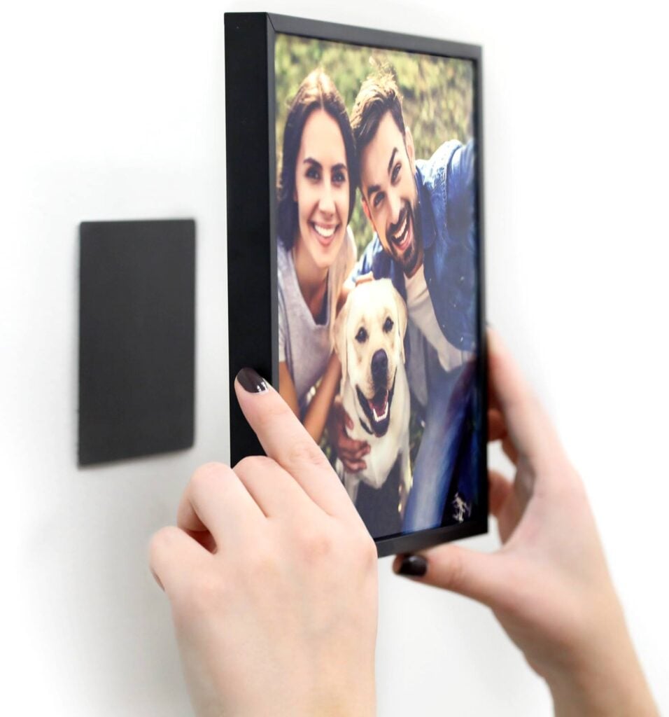 person hanging tilepix on wall