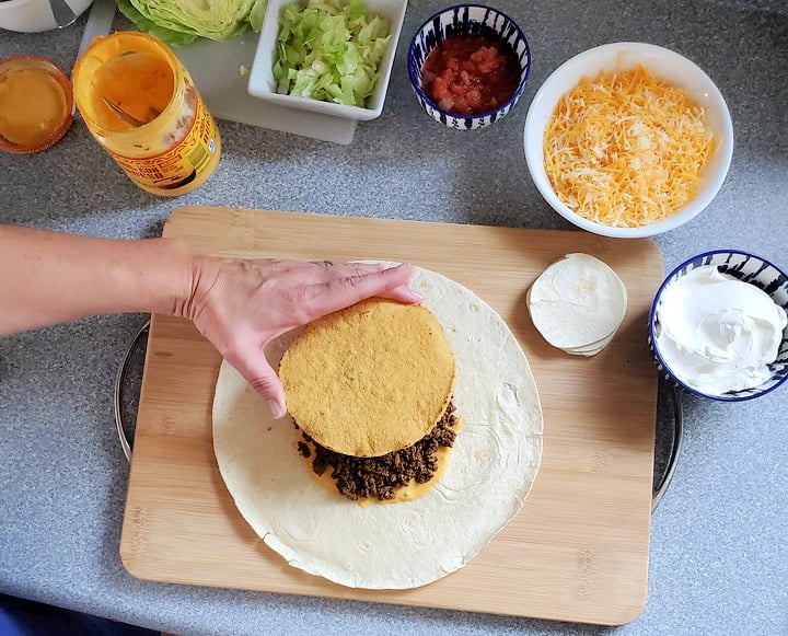 adding tostadas to homemade crunchwraps