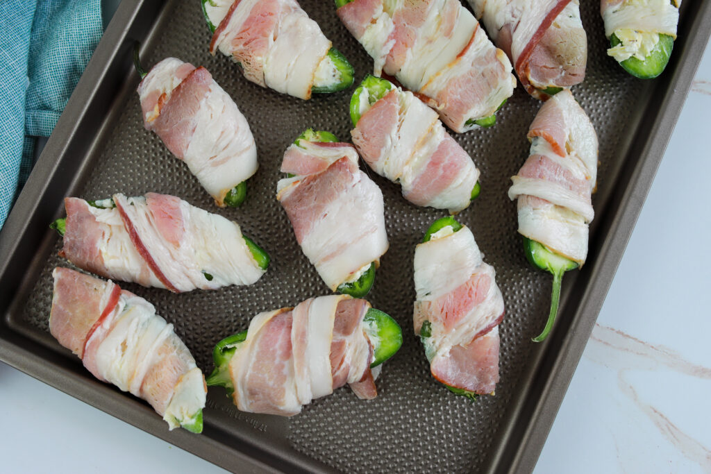 jalapeno poppers on baking sheet