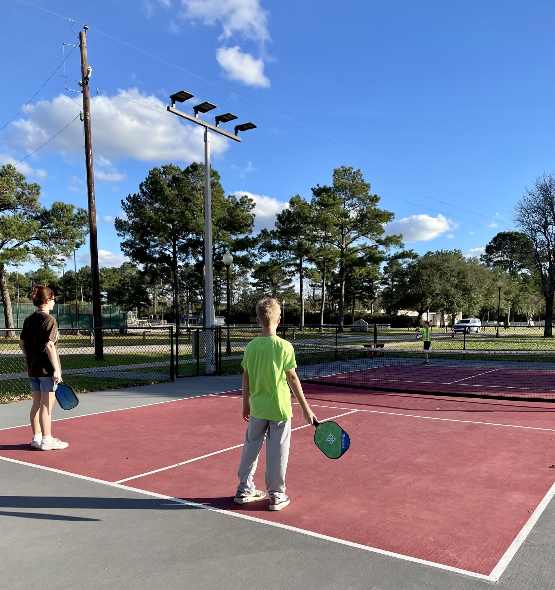 young kids playing pickleball