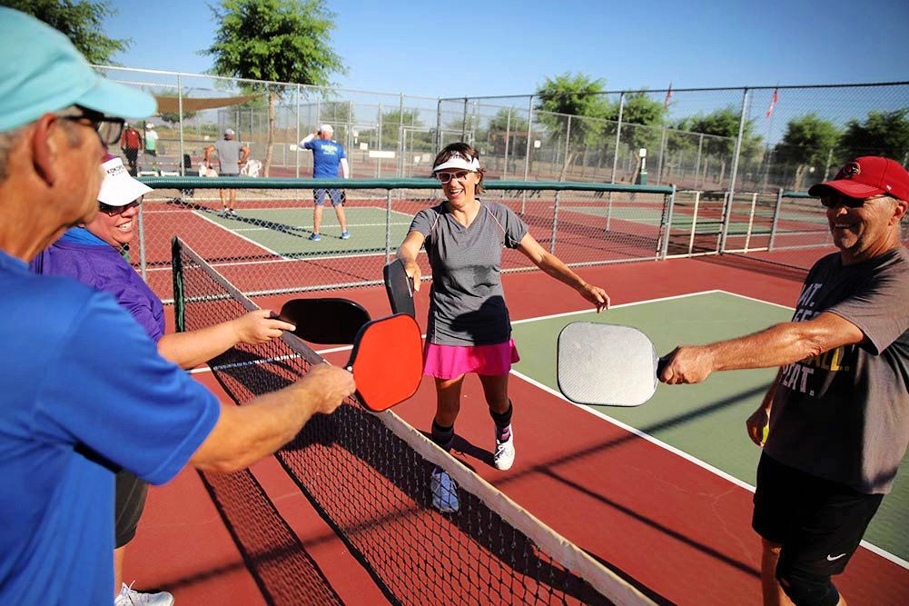 older people playing pickleball